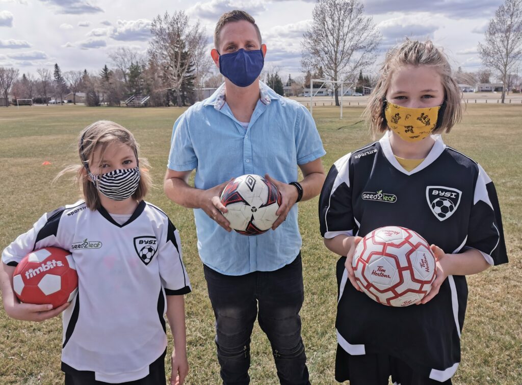 Owner Daryl at Soccer game with girl soccer players
